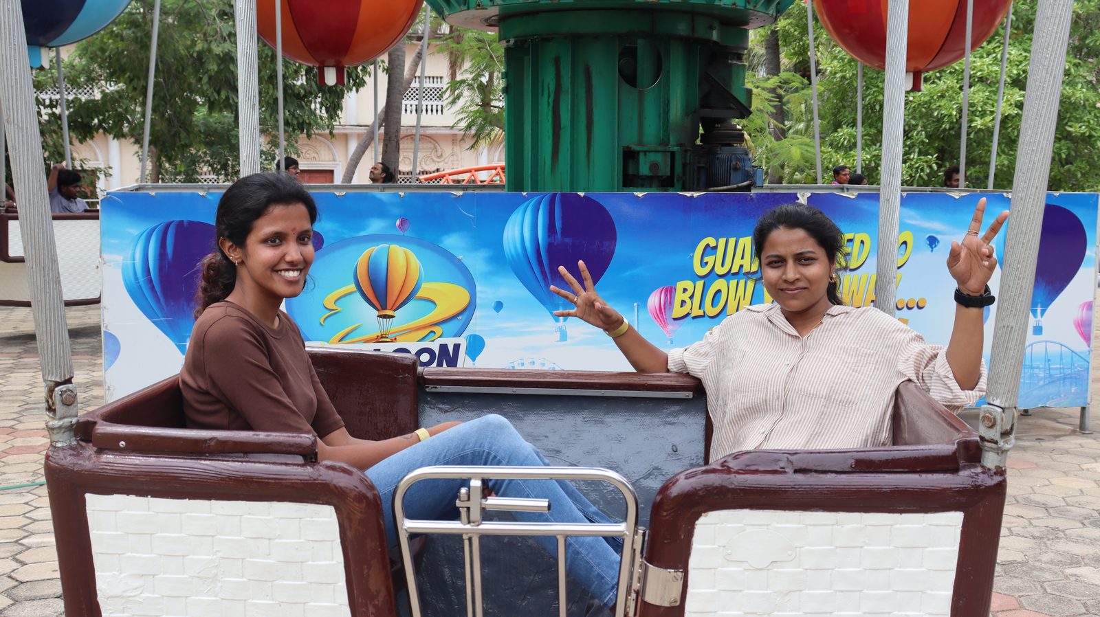 Two Guires colleagues smiling on the balloon ride at the theme park