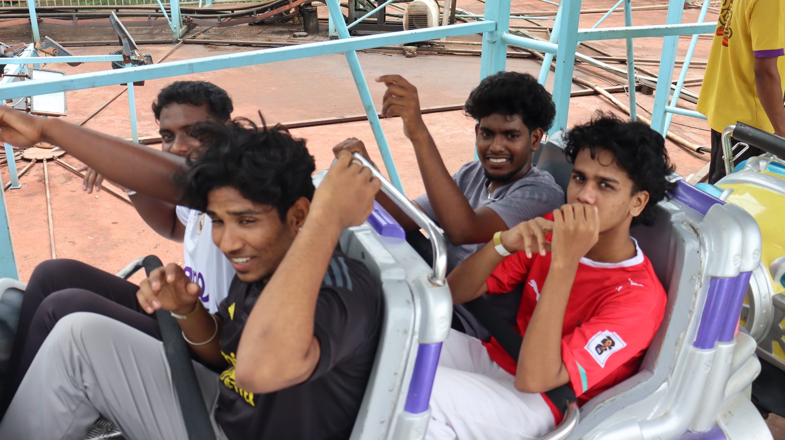 Guires colleagues bracing for a spinning ride at the theme park