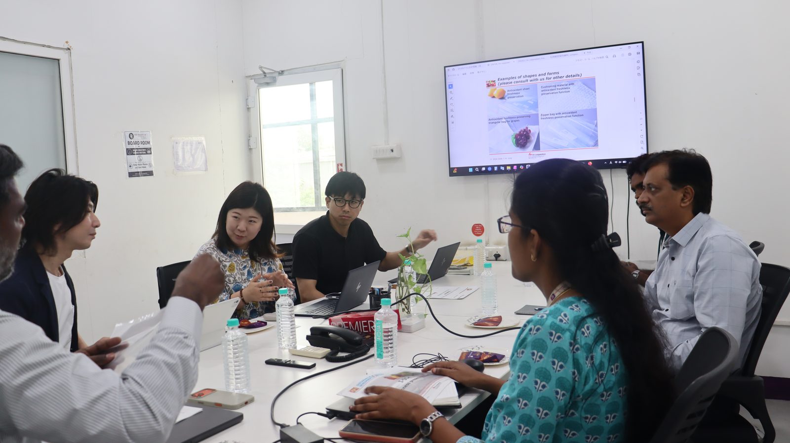Japanese delegation presenting antioxidant freshness-preservation packaging to the Guires Research Labs team in the boardroom
